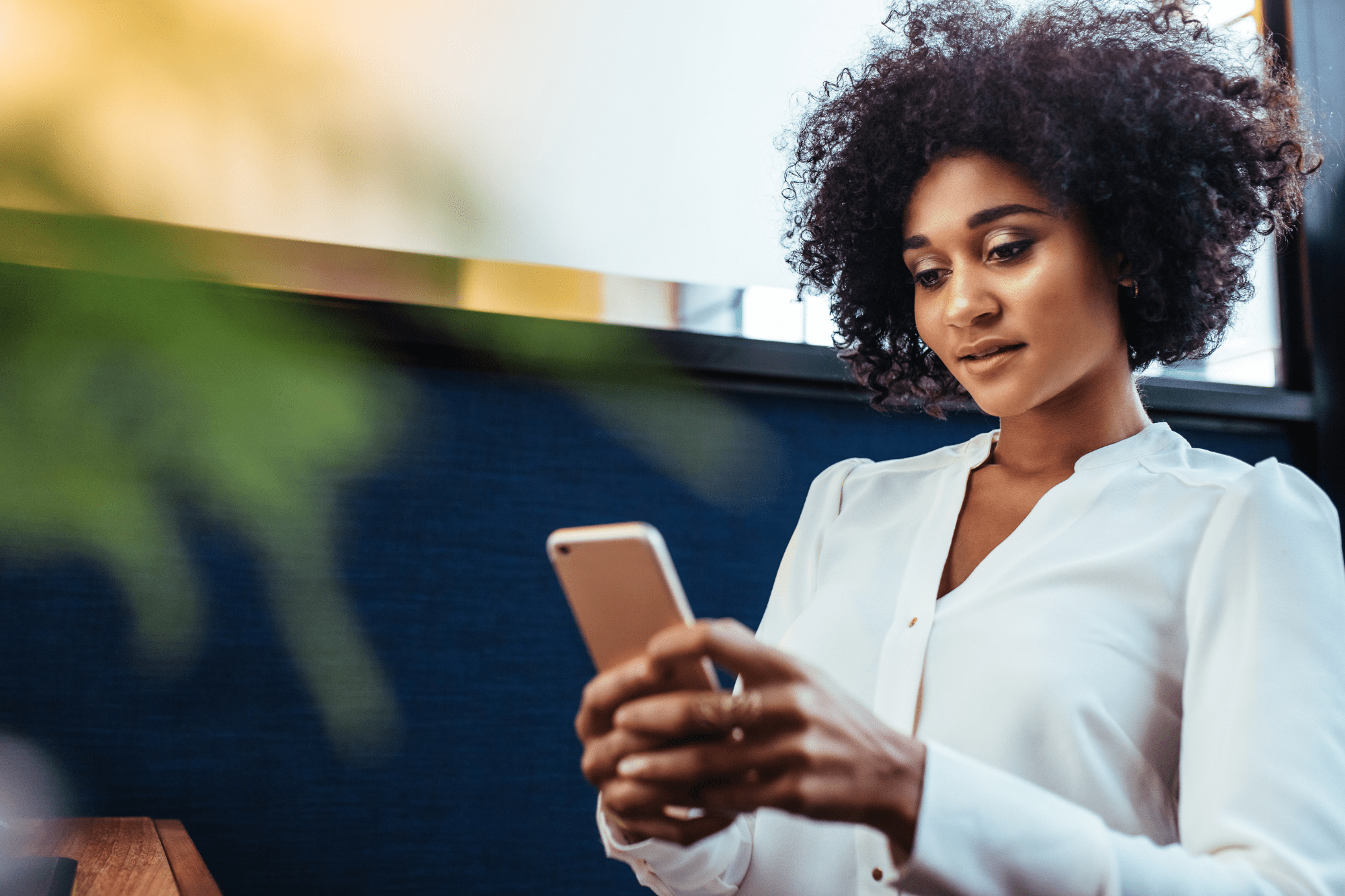 Black woman looking at her phone
